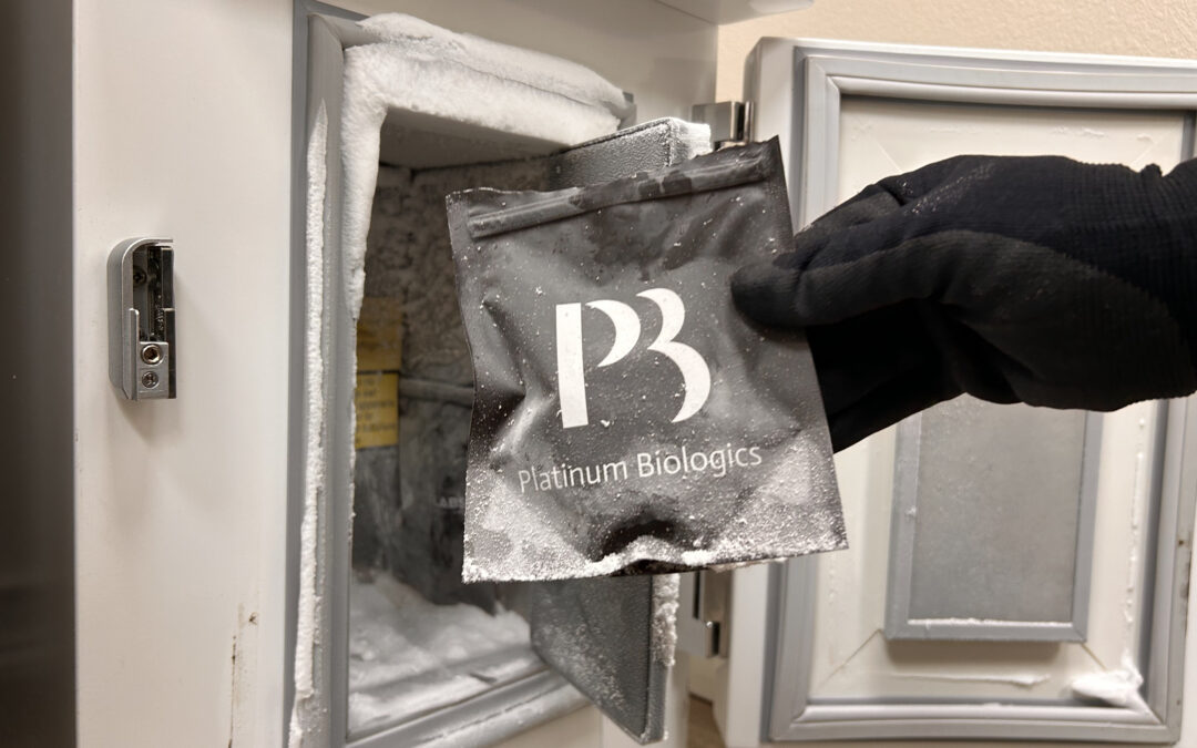 A hand holding stem cells right outside of a fridge at a clinic in Waco, TX
